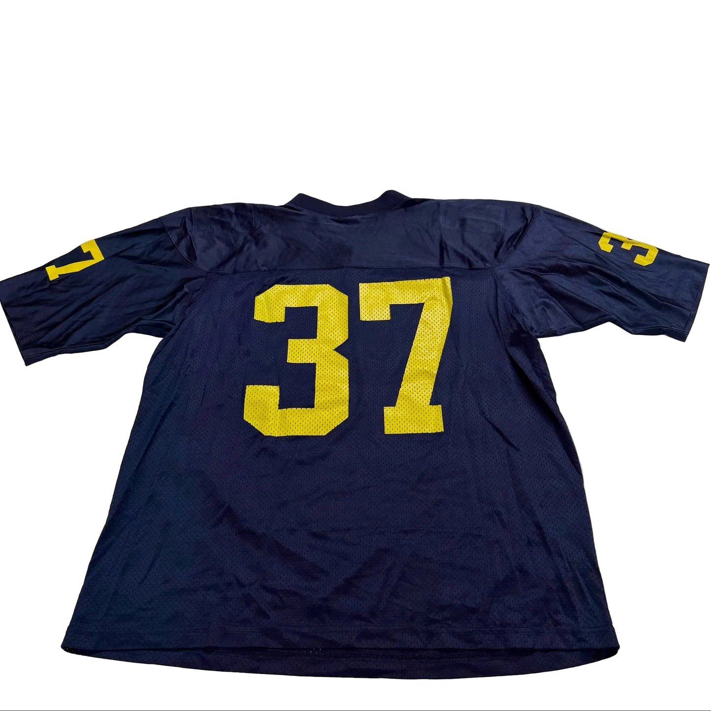 Navy blue sports jersey with yellow number 37 on a white surface
