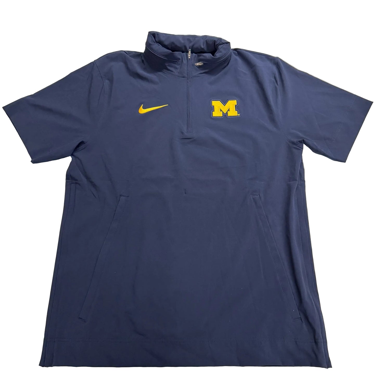 Navy blue quarter-zip shirt with Nike logo on a light gray background
