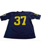 Navy blue sports jersey with yellow number 37 on a white surface