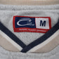 Close-up of a University of Michigan crewneck sweatshirt collar with a V-neck trim in heather gray, navy blue, and cream, featuring a red and white Cadre brand label.