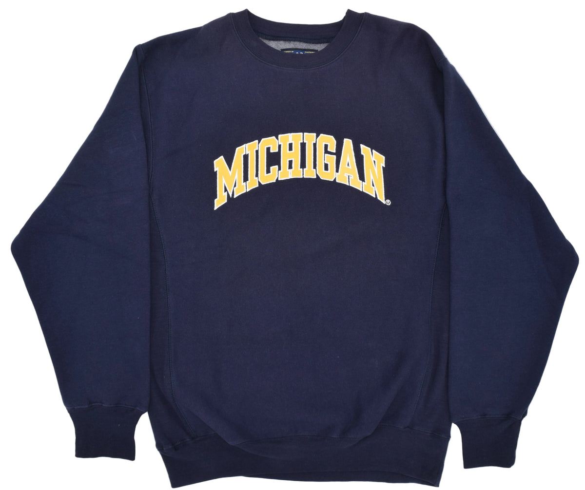 University of Michigan navy blue crewneck sweatshirt featuring the word 'MICHIGAN' embroidered in yellow letters with a white outline across the chest.