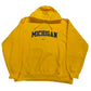 Yellow hoodie with 'Michigan' text on a white surface
