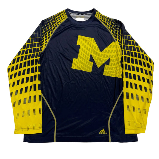 Navy athletic shirt with yellow 'M' logo and Adidas branding on a white background