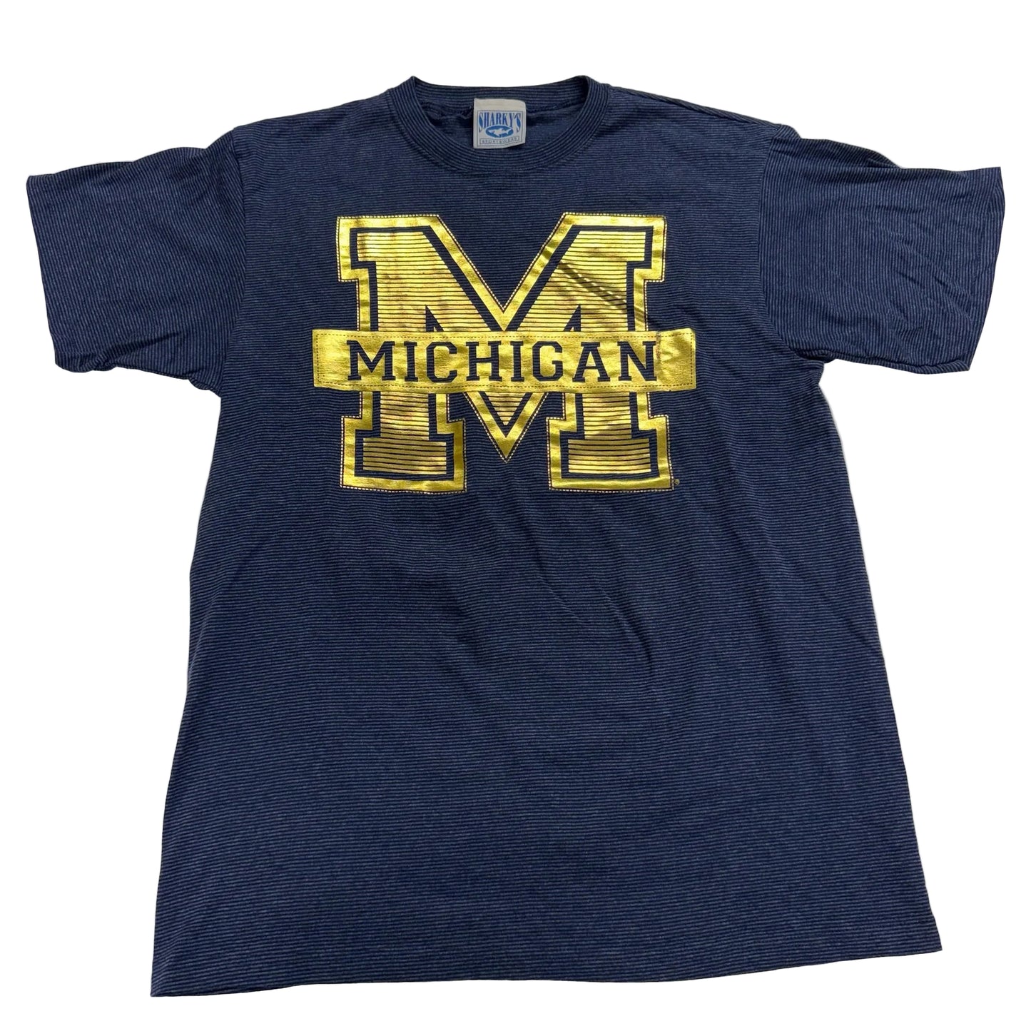 Navy blue t-shirt with gold 'Michigan' logo on a white background