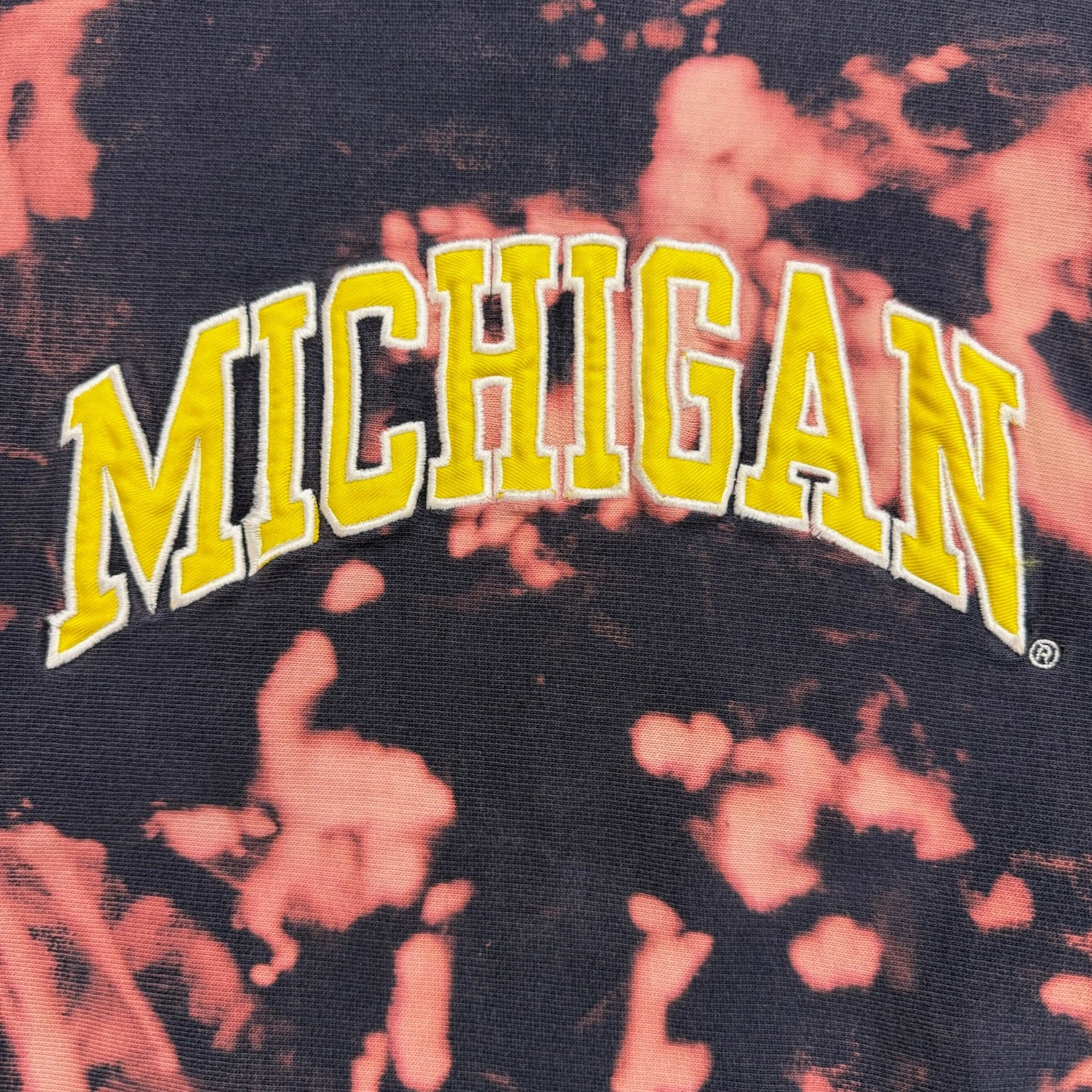Tie-dye shirt with 'MICHIGAN' text in yellow on a dark background