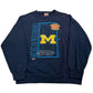Navy blue sweatshirt with Michigan Wolverines logo on a white background