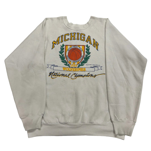 Gray sweatshirt with 'Michigan Wolverines National Champions' text and logo on a white background