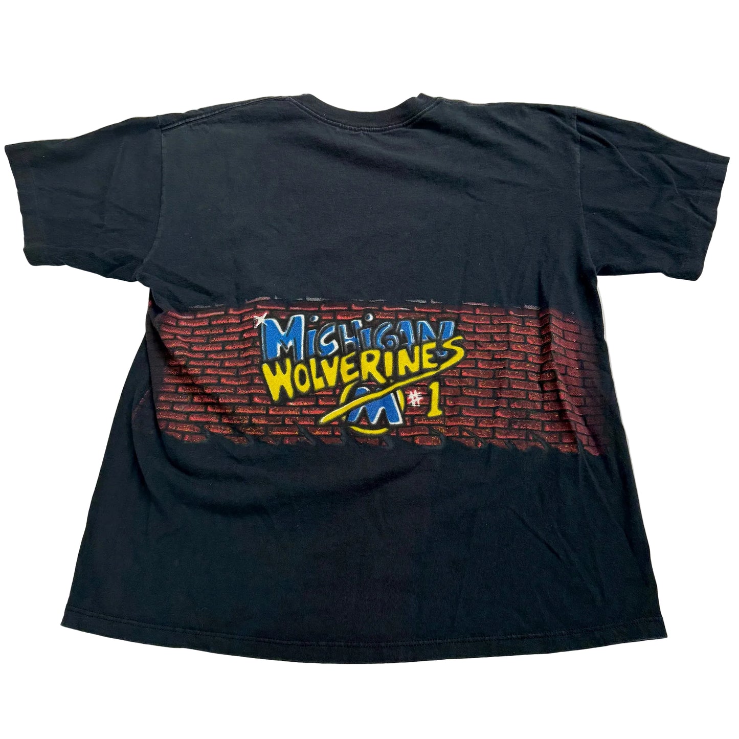 Black t-shirt with 'Michigan Wolverine' graphic on a white surface
