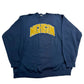 Blue sweatshirt with 'MICHIGAN' printed in yellow on a white surface