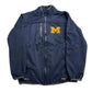 Blue jacket with a yellow 'M' logo on a light gray background