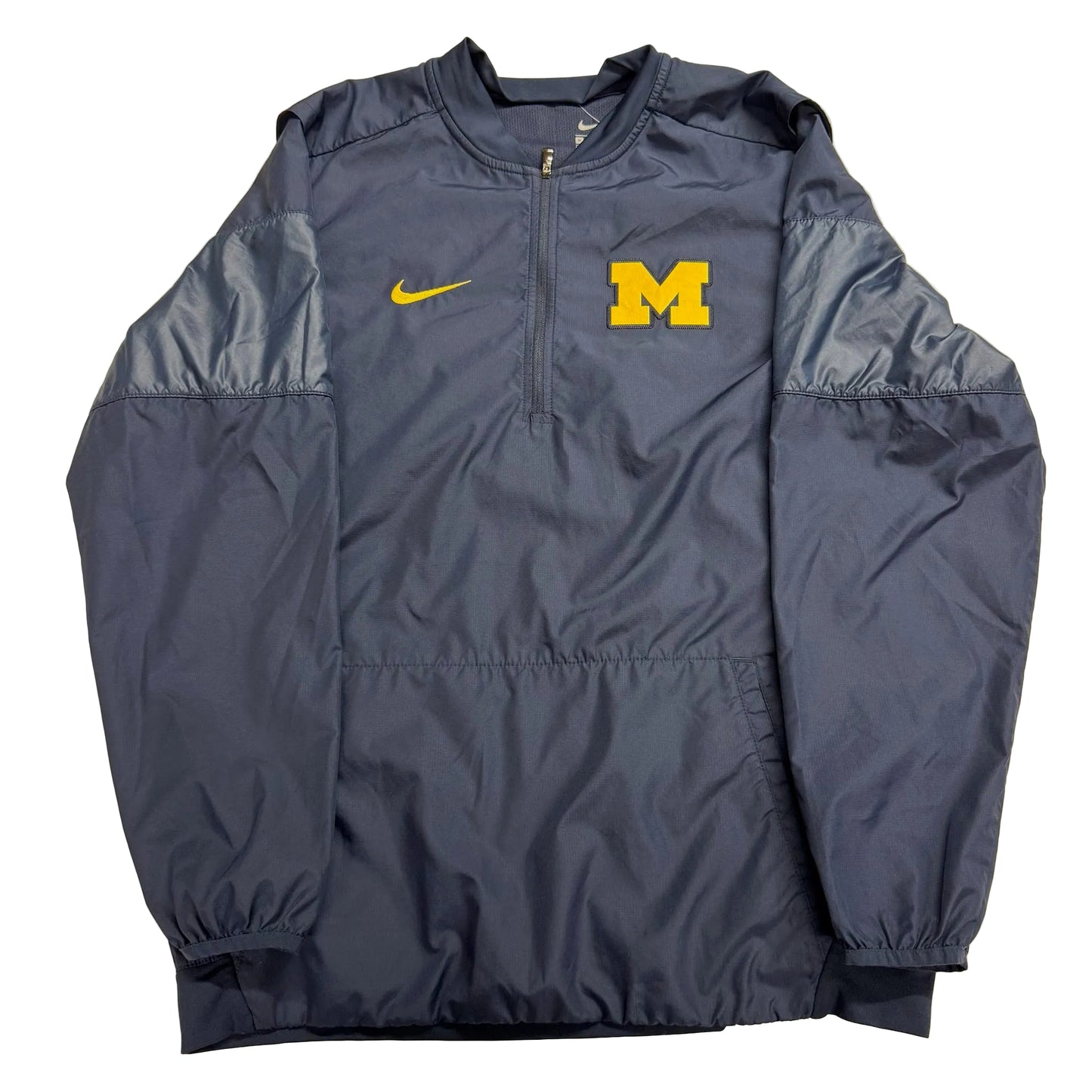 Navy blue jacket with yellow Nike logo and 'M' on a beige background