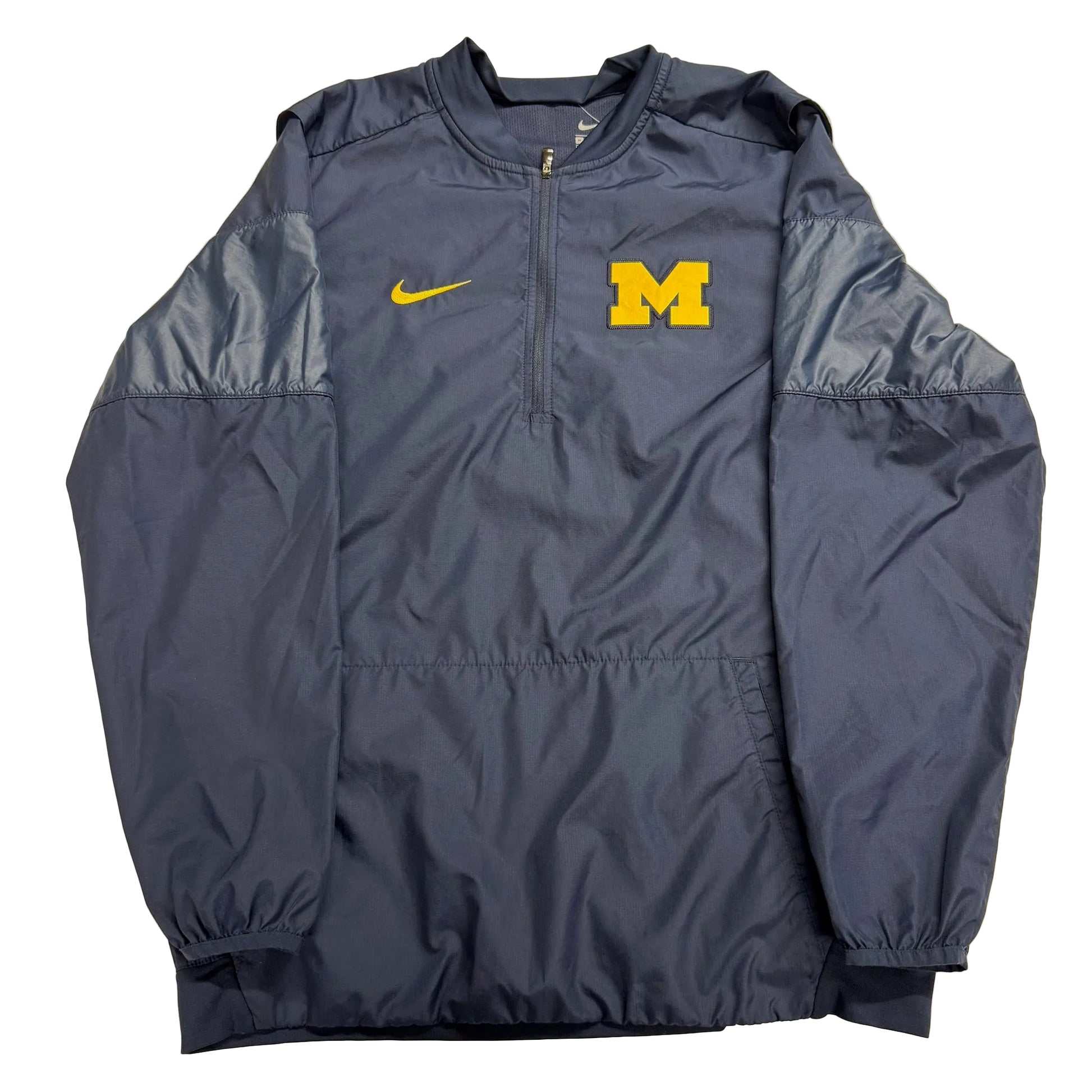 Navy blue jacket with yellow Nike logo and 'M' on a beige background