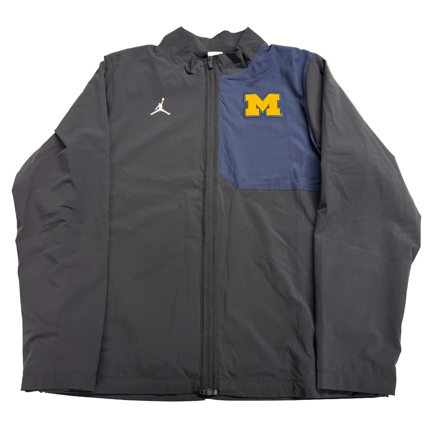 Gray jacket with Jordan logo on left side and Michigan logo on right side, on a light gray background