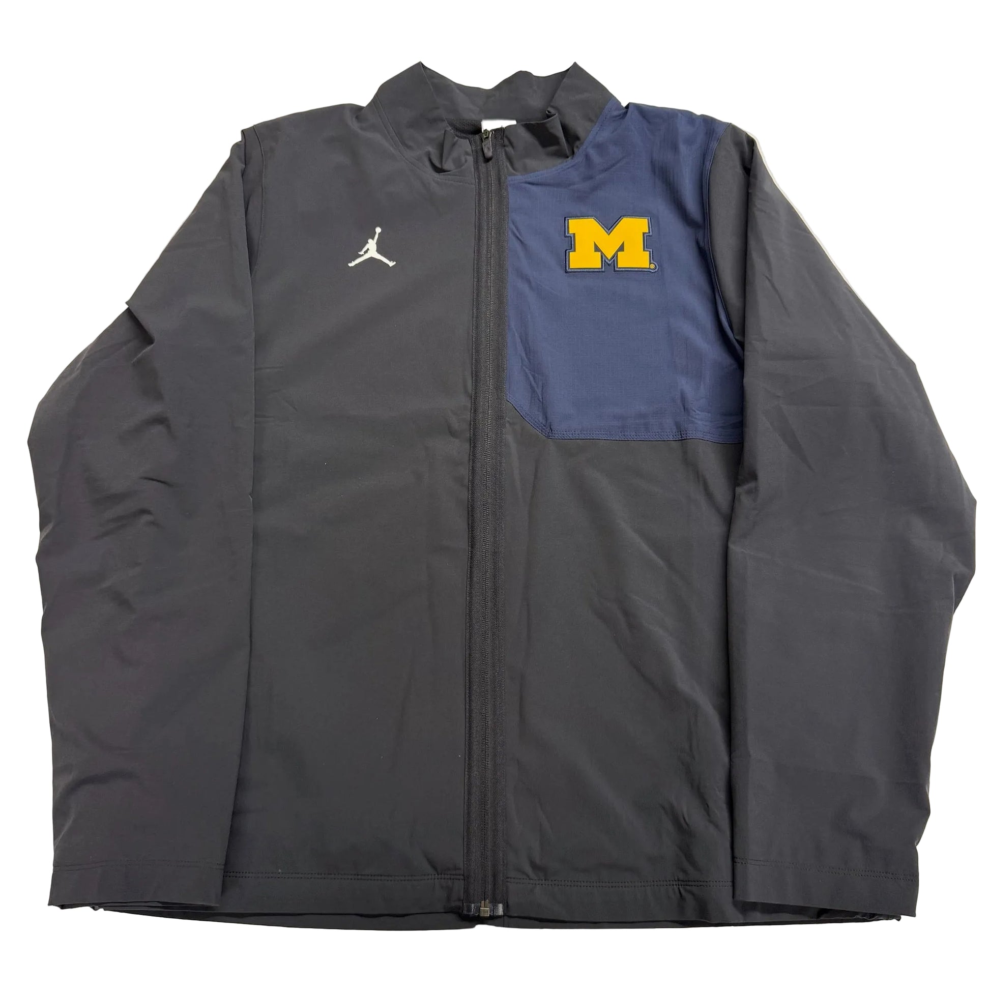 Gray jacket with Jordan logo on left side and Michigan logo on right side, on a light gray background