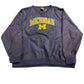 Navy sweatshirt with 'Michigan' printed on it, laid flat on a light-colored surface.