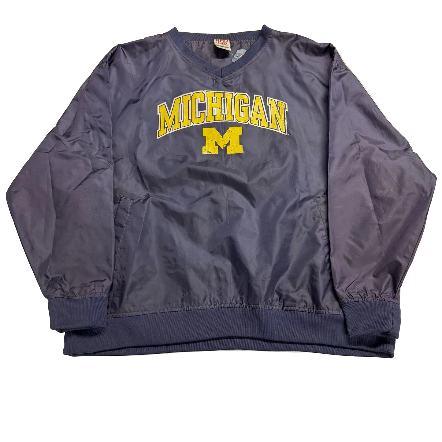 Navy sweatshirt with 'Michigan' printed on it, laid flat on a light-colored surface.