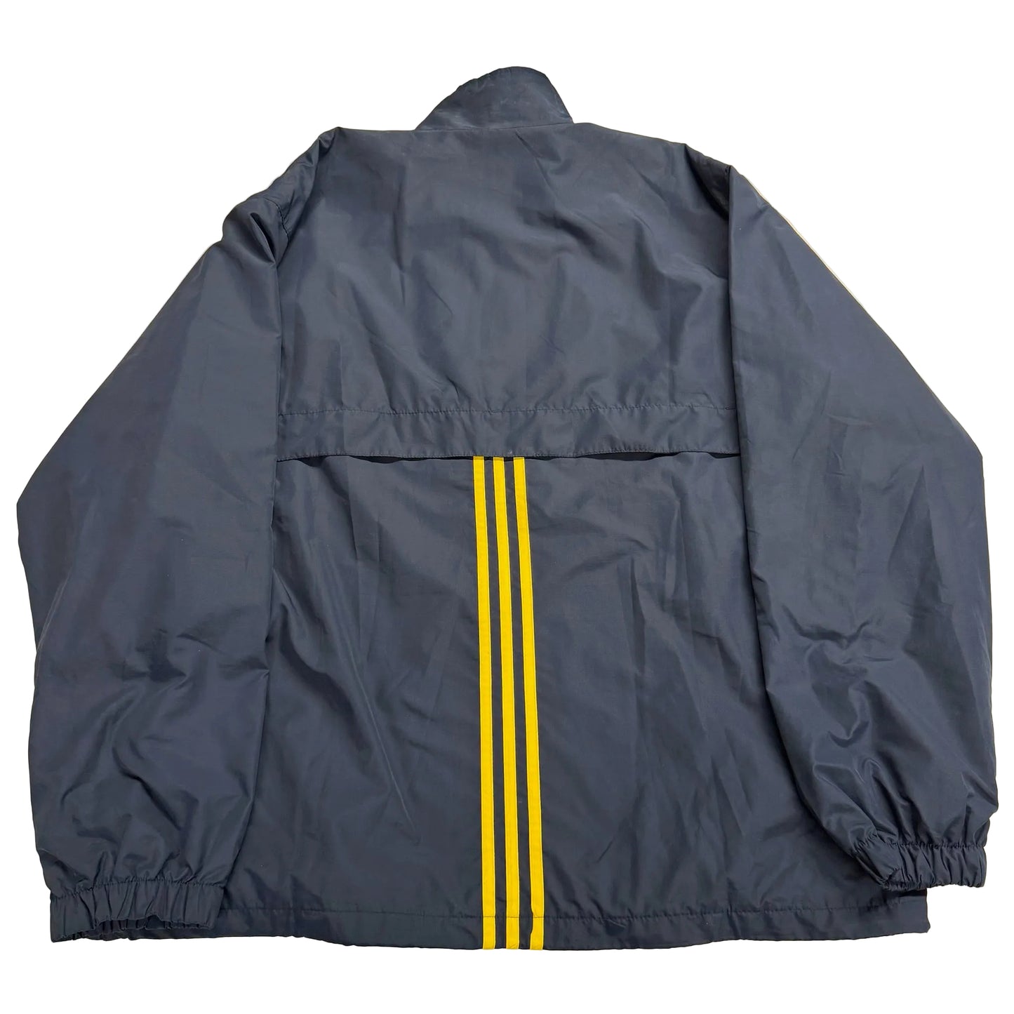 Navy blue jacket with yellow stripes on a beige surface